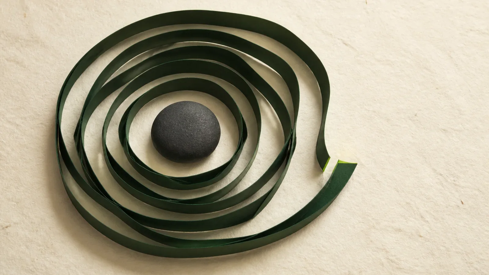A row of tiles shifting from identical squares to imperfect, hand-formed shapes, joined by one green line